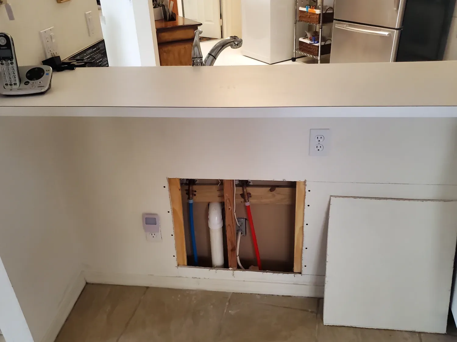 PEX supply piping at kitchen wall opening