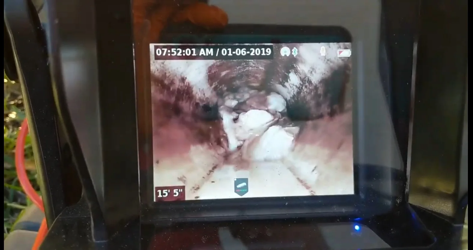 Sewer camera monitor showing the interior of a drain line